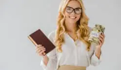 beautiful blond woman holding a jar of money and a book of business to demonstrate income producing assets